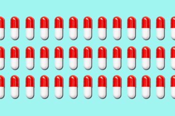 three rows of medical capsules on a blue background.